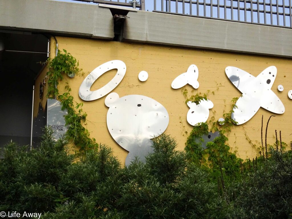 Mirrored street art display along bridge in Tampere